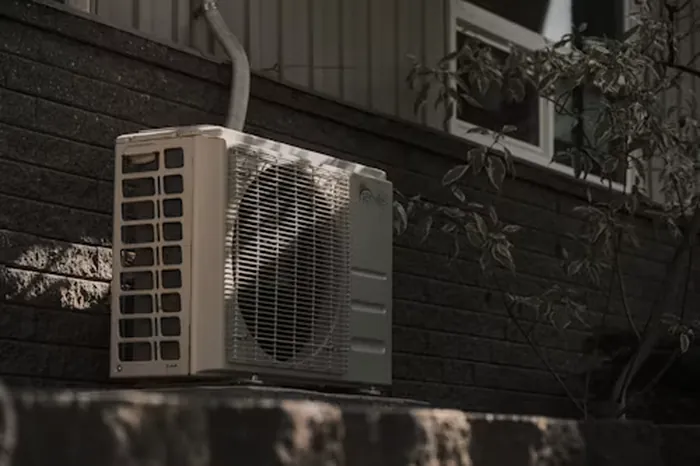 HVAC technician servicing an outdoor AC unit in Lebanon